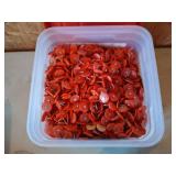 Almost full bucket of 7/8" round plastic cap