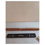 Two old levels, 24-in wooden, and 18 inch cast