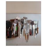 Lots of assorted kitchen utensils, mostly spatulas