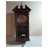 Antique wooden pendulum wall clock with beveled