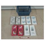 9 small Christmas gift boxes in small plastic tub