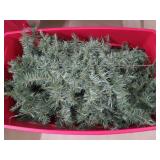 Christmas tree in large plastic rolling tote w/