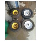 Two wheelbarrow wheels and tires and two front