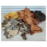 Leather scraps and pieces in plastic tub with lid