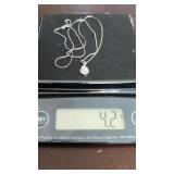 Diamond halo infinity pendant unsure of carat