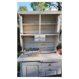 antique kitchen cabinet with cutting board and