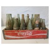 Wooden Coca-Cola soda crate full of old glass