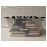 Plastic tub of assorted books