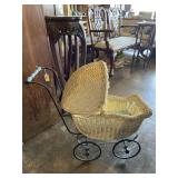Antique wicker doll carriage with movable cover.