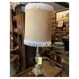 Metal brass looking lamp with fringed lampshade
