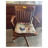 Vintage wood swivel desk chair on rollers