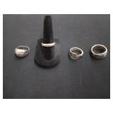 Four assorted silver rings, size 6, 7, 7, 8 1/2.