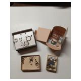 Assorted jewelry boxes with earrings, necklaces,