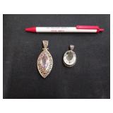 2 sterling silver pendants, one has a purple