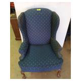 Blue chair with wooden feet, missing one arm rest