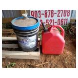 5 gallon gas jug, and STP bucket of fluid