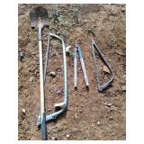 Two hand saws, shovel and a pair of pruners