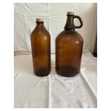 Two glass Amber colored vintage Clorox jugs - o