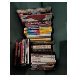 Plastic tub of assorted dvds, VHS tapes, books
