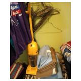 Lower closet contents: hanging clothes, blankets,