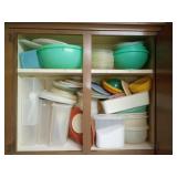 Two cabinets full of Tupperware and lids