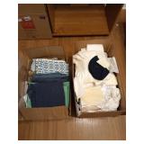 Two boxes full of assorted fabric