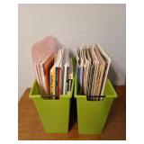 Two green containers of cross stitch books, and