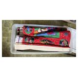 Plastic tub of Christmas, tapestry rugs, and
