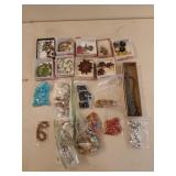20 containers of assorted costume jewelry of