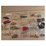 20 bags of assorted costume jewelry, mostly