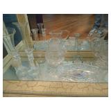 Bottom shelf contents: vases, candle holders,