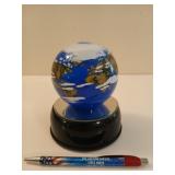 Neat world globe paperweight on light
