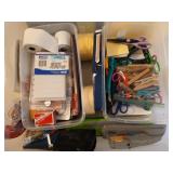 Plastic tub of assorted office supplies