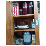Contents of 3 shelves: plastic Coca-Cola cups,