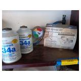 Two cans of refrigerant 134a, full?, and a
