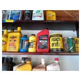 Middle shelf full of assorted vehicle oils, motor