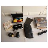 Two fishing reels, a Neet holster, a pen set,