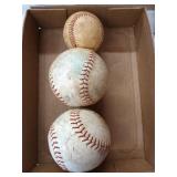 Two soft balls and a baseball. Some of the