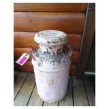 Old pink milk can with peeling paint, 25 by 13 in