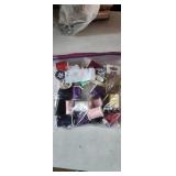 gallon sized bag full of sewing thread and pins