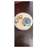 set of gold tone earrings and watch face