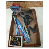 Flat of plastic clamps and hacksaws