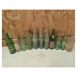 Collection of old bottles, mostly Coca-Cola,