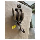 Old wood and metal wheel block and tackle pulley