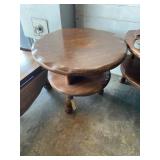 Round table with two shelves, and three legs,