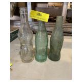 Two Coca-Cola and one delicious soda, glass