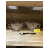 Depressing glass creamer and sugar bowls sandwich