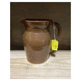 Brown pottery water pitcher about 8 inches tall
