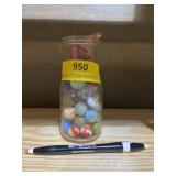Small glass milk jar with assorted marbles