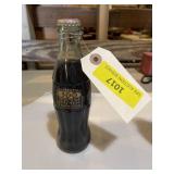Collectible Coca-Cola bottle celebrating 100